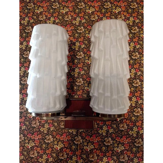 Pair of 50s sconces with wood and brass frame, opaque glass reflectors Up to 250V (Europe/UK Standard).The wiring of this...