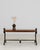 A bold Brutalist coffee table defined by its sculptural wrought iron base and strong geometric presence. The raw,...