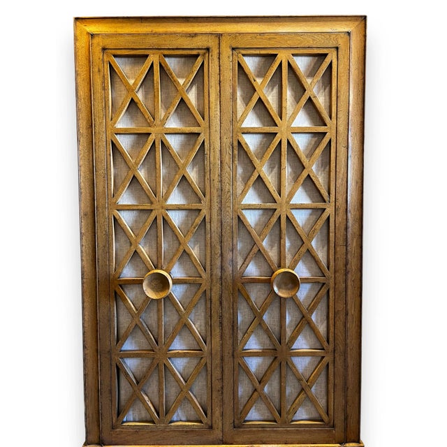 Midcentury two door armoire with 4 shelves, two pull out drawers, and a pull out TV swivel. Each door has a linen fabric...