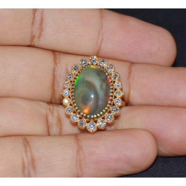 Gorgeous 18K solid gold 9.25CTS natural diamond and opal cocktail ring. This ring features a huge 8.20CTS natural opal in...
