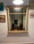 Graceful Neoclassic / Roman Revival rectangular mirror with pickled ivory finish accented with burnished gilding. Fluted...
