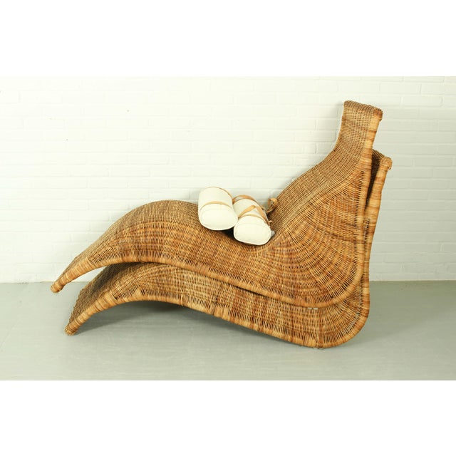 This pair of IKEA Karlskrona lounge chairs, designed by Karl Malvall, features a woven rattan construction with a relaxed,...
