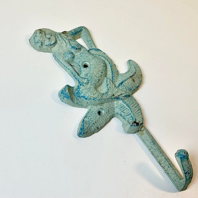 We couldn’t pick this fabulous Wall Hook up fast enough when we saw it. The cast iron item is a Mermaid sitting on a...