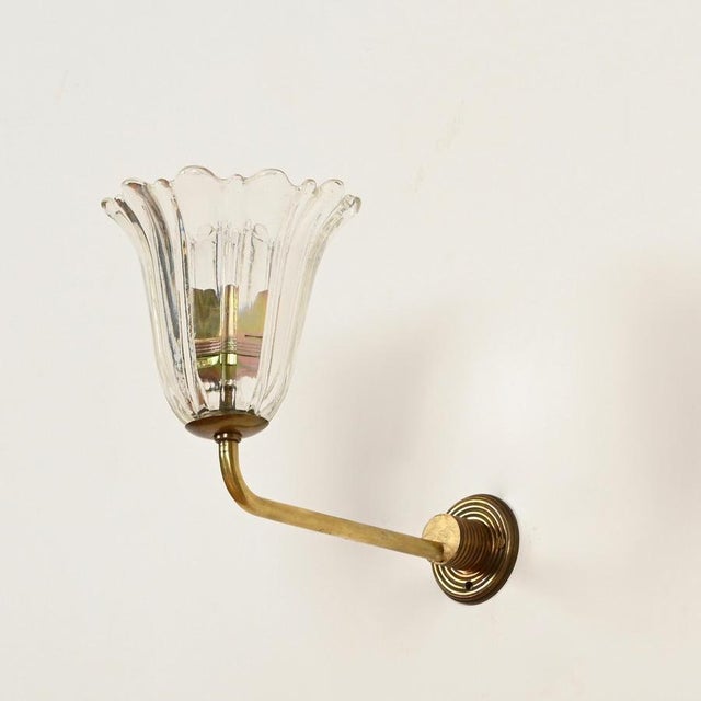 Marvelous pair of bellflower-shaped sconces in murano mouth-blown crystal glass and solid brass. These wonderful lights...