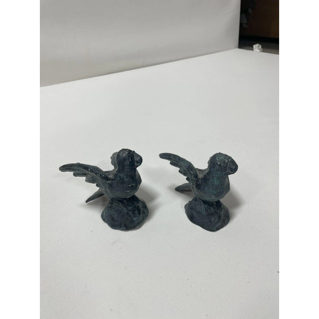 Pair of cast iron bird with a beautiful amount of patina. The main color is gray with some blue detailing. Maker is...