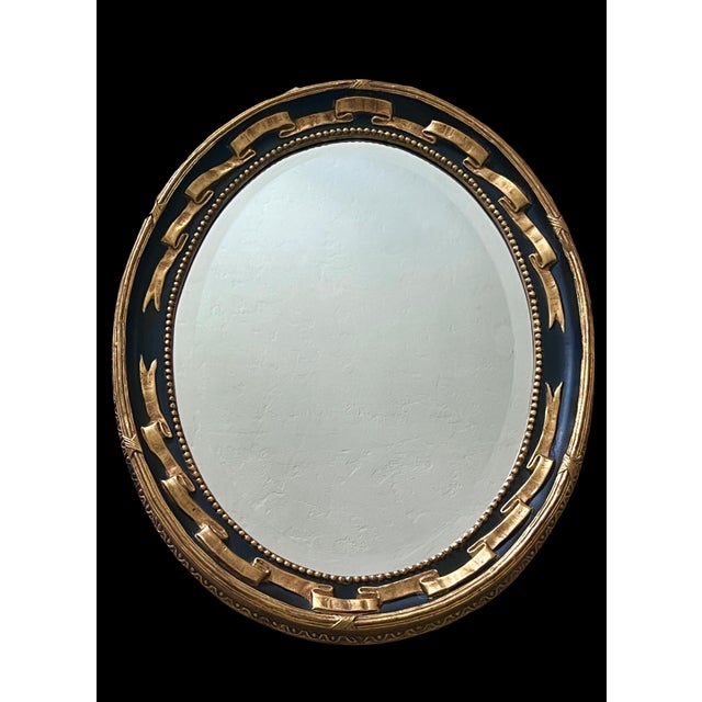 Elegant eye catching Regency style oval bevelled wall mirror by prestigious Friedman Brothers Decorative Arts Inc....