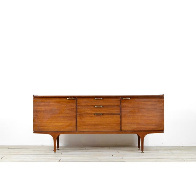 Brass and Teak Sideboard from Meredew, 1960s, in Very Good conditions. Designed 1960 to 1969 This piece has an attribution...