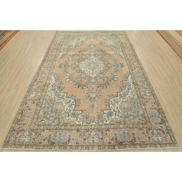An authentic vintage traditional Tabriz rug hand-knotted with an all-wool pile on a cotton foundation. This oriental rug...
