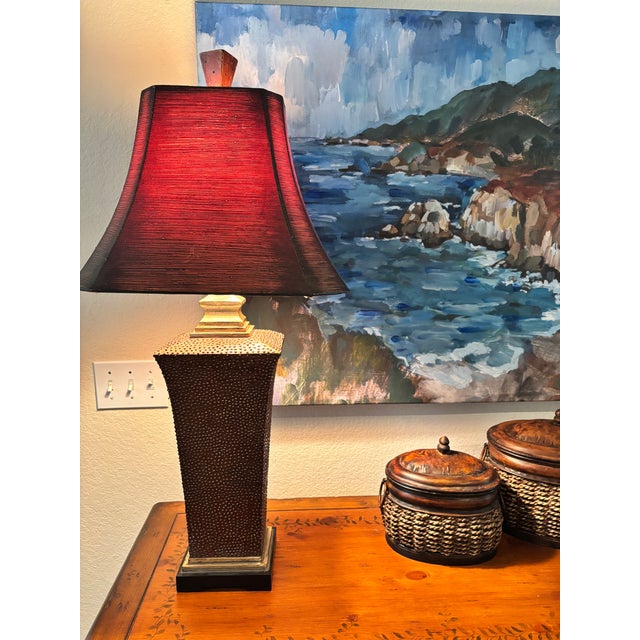 This Uttermost table lamp features a sculptural textured ceramic base inspired by classic Tuscan and Mediterranean design....