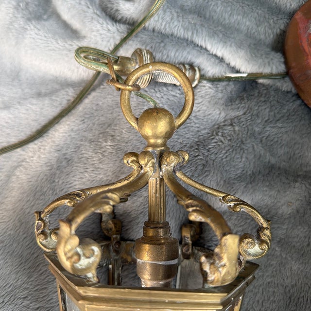 An elegant mid-to-late 20th-century French-inspired hexagonal pendant lantern. This piece features six tapered glass...