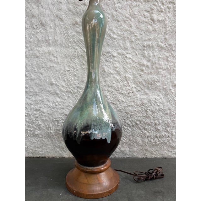 Very large ceramic lamp with a beautiful greenish blue drip glaze finish over a very dark brown base that looks black....