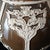 This is a very impressive ceramic vase. 19" tall and 9" wide, a soft brown glaze with raised white neoclassical designs...