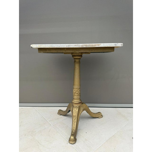 Authentic French bistro table from the Belle Époque period, dating circa 1890–1910, featuring a white marble top with...