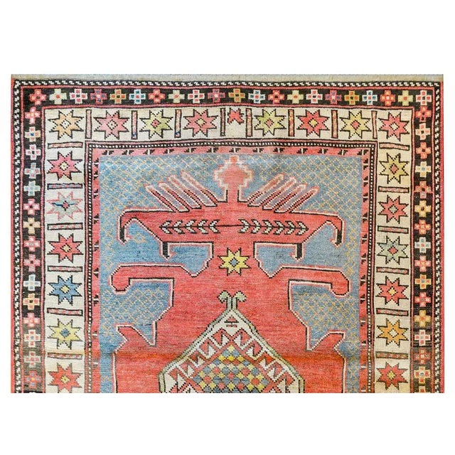 A fantastic early 20th century Azerbaijani Kazak rug with a large medallion with a white diamond in the center surrounded...