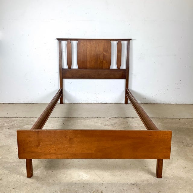 Bring mid-century modern charm to your bedroom with this walnut twin bed frame. Featuring clean lines, tapered legs, and a...
