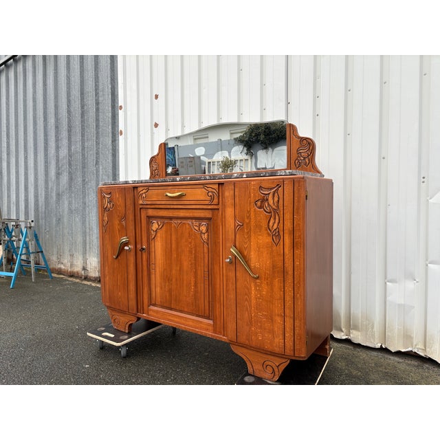 Elegant French Art Nouveau sideboard dating from the early 20th century, crafted in solid wood and richly carved with...