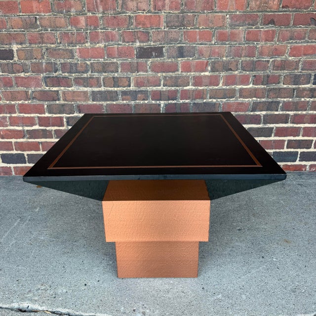 This is a beautiful custom studio made game table with a black finished top and copper inlays with a tiered copper...