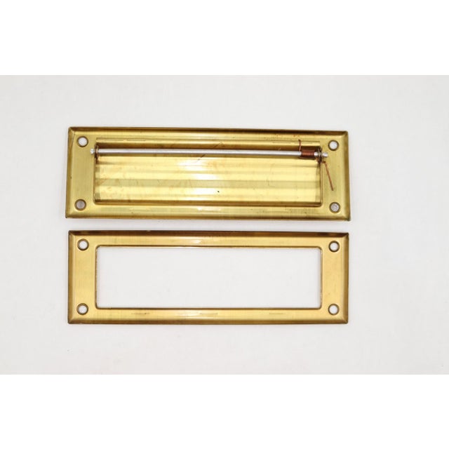 Vintage spring loaded mail slot that opens inward at 45 degrees to allow mail through. Made of brass with a polished...