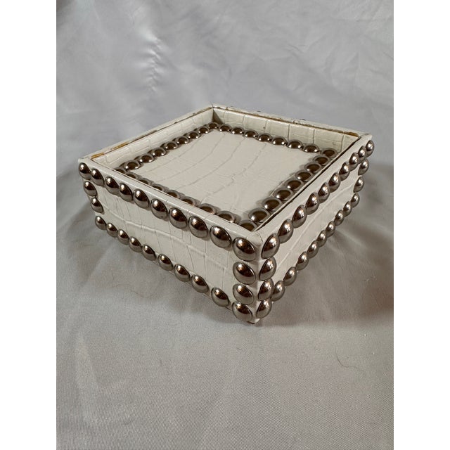 A set of four alligator print coasters that nestle into a neat box all with silver nail heads, very rock ‘n’ roll