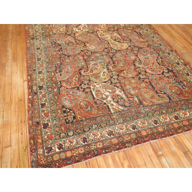 Large Gallery size Persian Rug with a large-scale spiraling boteh design with areas of age-related wear. circa 1920...