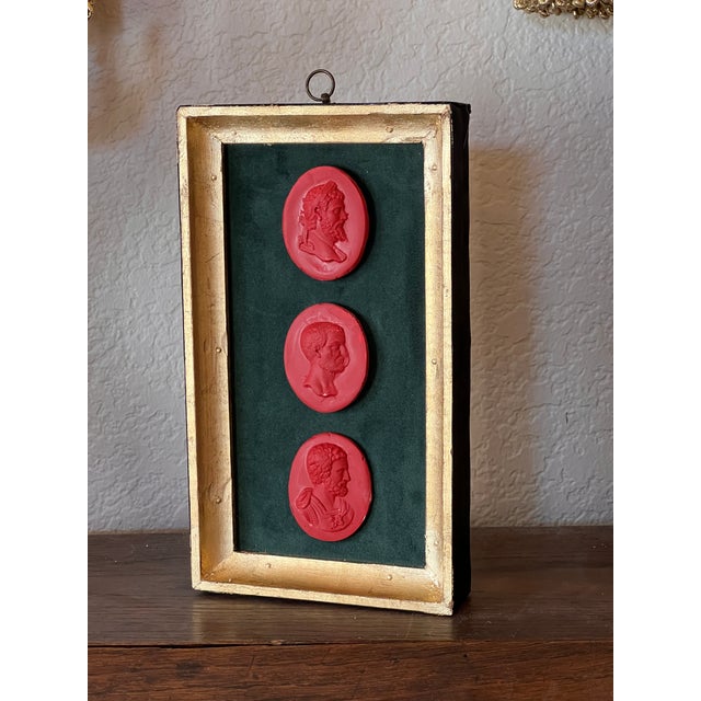 "The tree Emperors", classical red glazed arrangement with three casts depicting roman Emperors. The casts are resting on...
