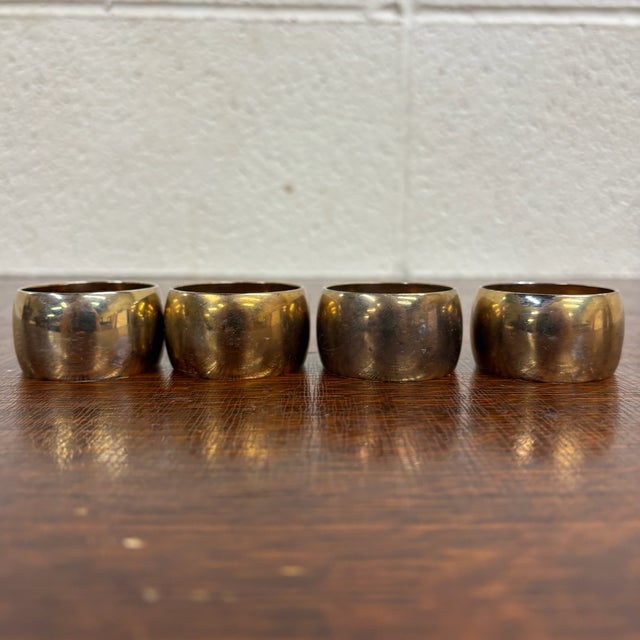 This is a gorgeous full set of four vintage brass napkin rings. Dimensions: - 1.75 in wide - 1.75 in deep - 1 in tall