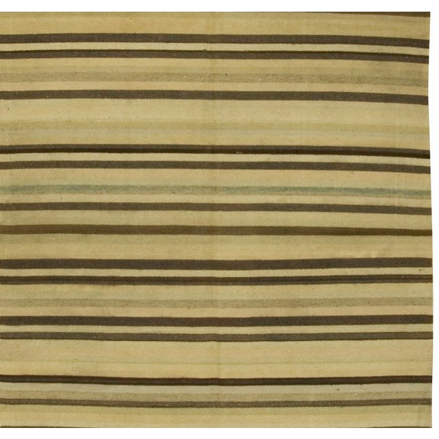 Offered is a vintage Turkish Kilim area rug featuring pale green stripes. Handwoven in the 1940s, this charming piece...