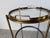 Elegant 1970s Maison Jansen Style Italian Hollywood Regency bar cart featuring a polished brass frame with three circular...