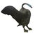 A commanding and elegantly weathered bronze sculpture of a swan in mid-display, featuring an impressive wingspan and a...