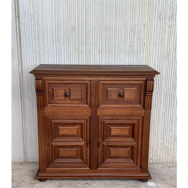 About From Northern Spain, constructed of solid walnut, the rectangular top with molded edge atop a conforming case...