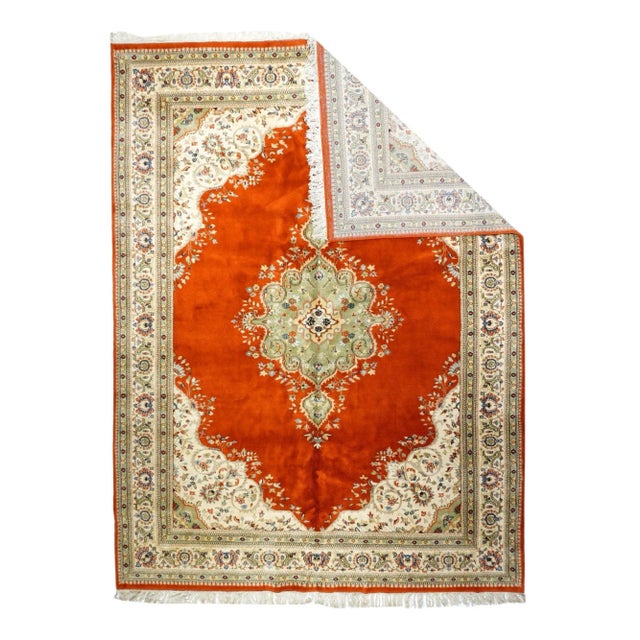 Tabriz Rug 8'10'' x 11'10''. The tomato red open field is centered by a lobed and pendanted green medallion with a barbed...