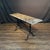 Elegant French bistro table featuring a long, narrow lovely early marble top raised on a classic Provencal slender black...