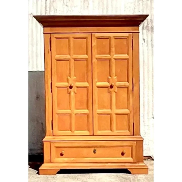This exceptional vintage Drexel pine armoire cabinet from the acclaimed "American Themes" collection beautifully showcases...