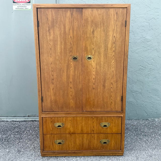 A versatile vintage armoire from Drexel’s Passages collection, crafted in a warm walnut finish with Campaign-inspired...
