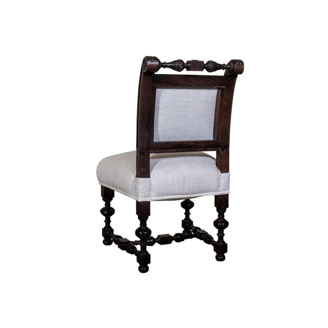 Wooden accent chair with turned legs and bun feet. Hand carved cresting.