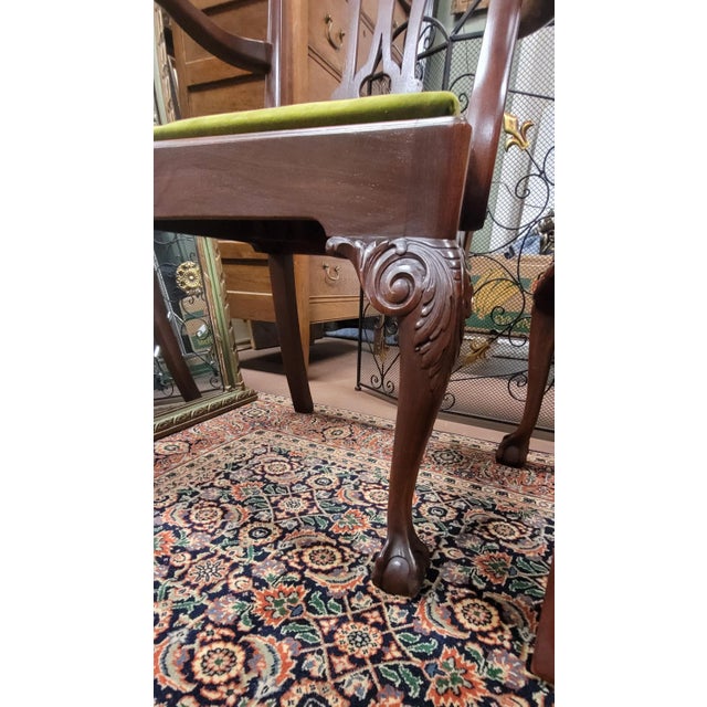 Super fine pair Of 1940s Chippendale Arm chairs in green velvet upholstery. The chairs feature beautifully carved and...