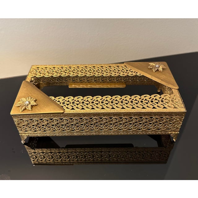 Mid-century filigree gold tone metal tissue box holder Floral appliqué on two corners with faux crystal century. Great...