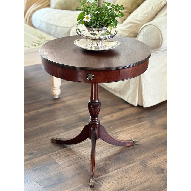 Elevate your interior with this exceptional mid-century traditional drum table by the renowned Lane Furniture Company....
