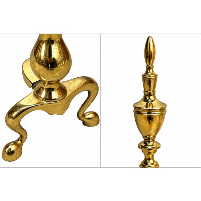 It is an impressive pair of tall vintage brass fireplace andirons featuring an elegant traditional design with finely...
