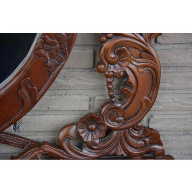 This ornate vanity features intricate Rococo Revival or Gothic-inspired hand-carvings with floral motifs and an elaborate...