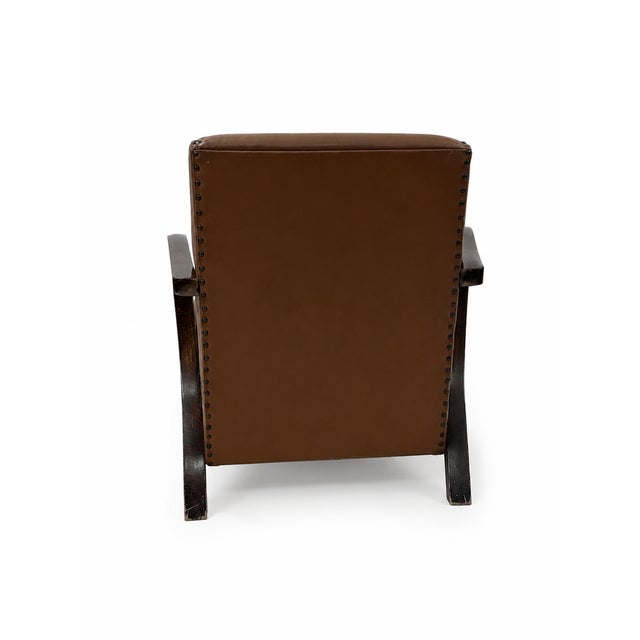 Italian-made armchair, 1940s. Wooden frame, padding, and brown Sky faux leather. Original condition; the flap is a sign of...
