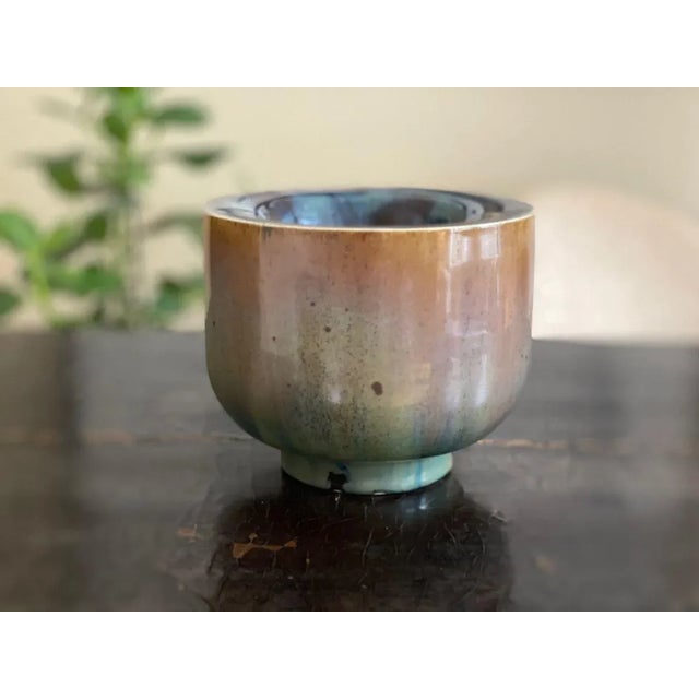 This beautiful multi-colored glazed (or called Kumme also) vase is one of Walther Zanders very thin walls the twisted...