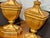 A handsome pair of carved wood urn-form table lamps featuring an antiqued gilt or distressed gold leaf finish with...