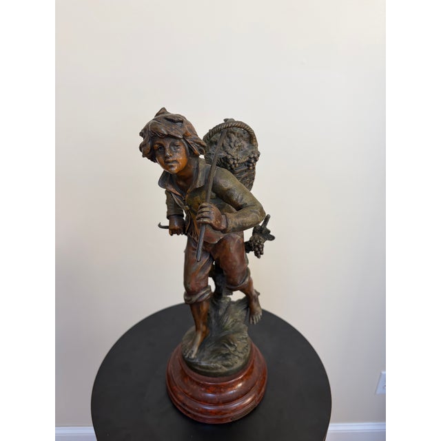 Late 19th- to early 20th-century French Vendangeur sculpture in brown-patinated cast spelter, styled after the mid-19th-...