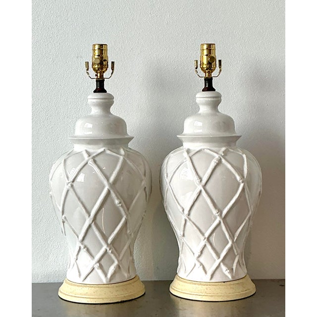 This exceptional pair of vintage table lamps exudes Hollywood Regency glamour with a timeless Chinoiserie influence....