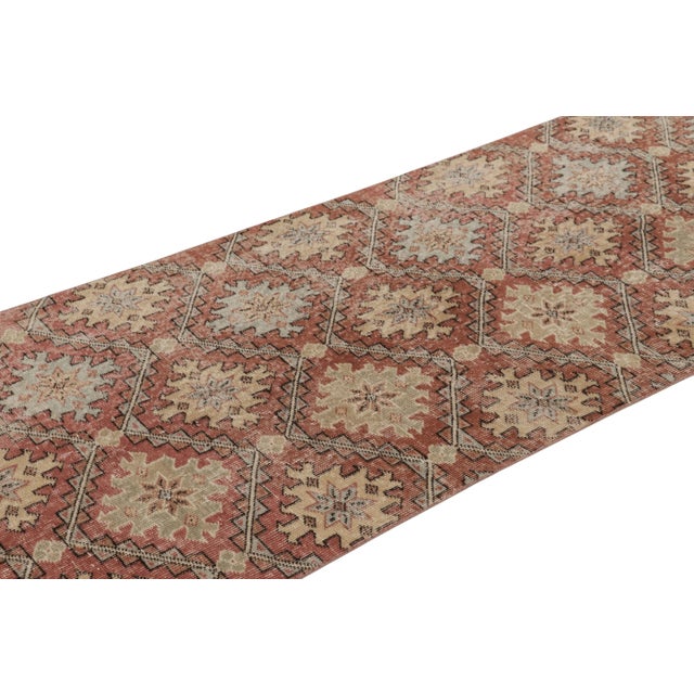 This vintage runner rug is a 3x11 Turkish distressed piece, made with hand-knotted wool circa mid-20th century. It is an...