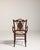 A refined Edwardian inlaid armchair crafted in richly toned mahogany, representing the transition from late Victorian...