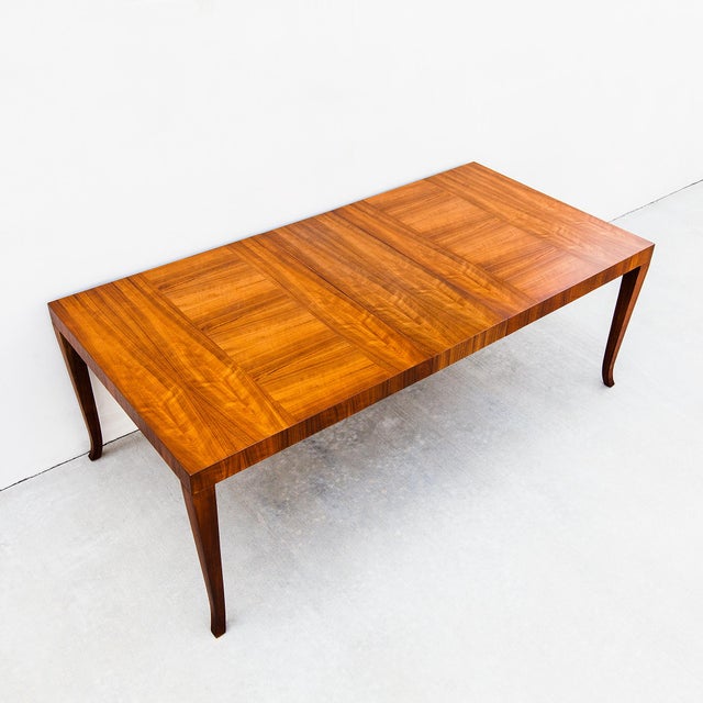 Vintage mid century modern saber leg walnut dining table by Widdicomb, made in the United States in 1957. With the two...