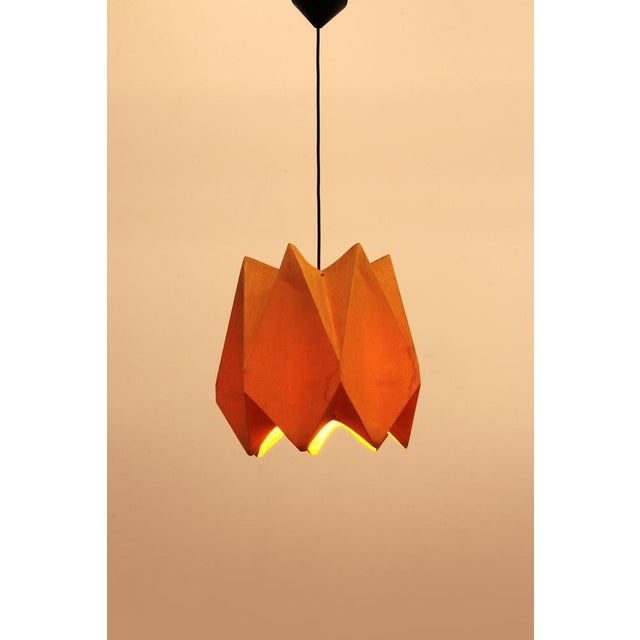 This is a beautiful lampshade with a very special shape, secured in a few places with some kind of beautifully crafted...