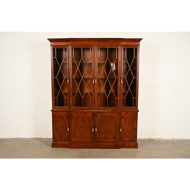 A gorgeous Georgian or Chippendale style breakfront bookcase cabinet or dining cabinet By Baker Furniture, "Historic...